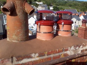 Top layers of loose bricks removed,re repointed.New pots fitted and cowls fitted to working chimneys.