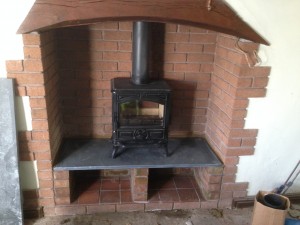 We suggested that to maximise space in the cottage a log store could be built underneath.To do this some reclaimed bricks were used for the pillars and a slate shelf cut and fitted.