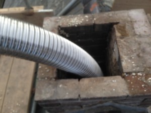 Top of the chimney.The old pot,damaged brickwork and flaunching repaired