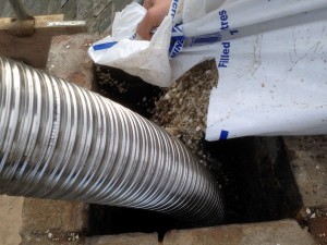 Vermeculite Insulation is poured into the chimney